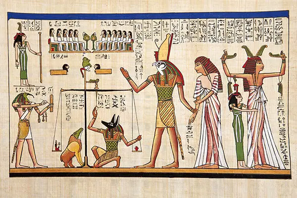Egyptian Anubis (with dog head) weighing heart of dead Osiris and Isis look on