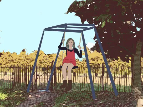 A girl happily sitting on a swing.